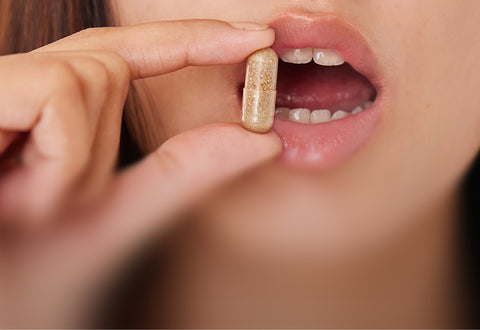 Pill close to womens mouth